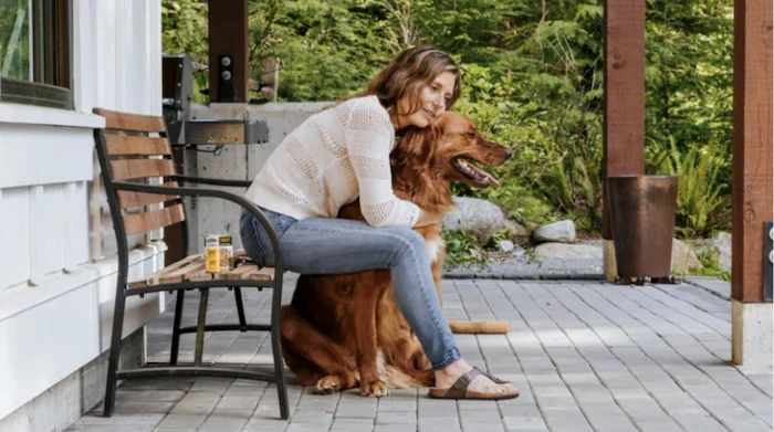 Pet owner showing affection to a golden retriever, reflecting trusted care